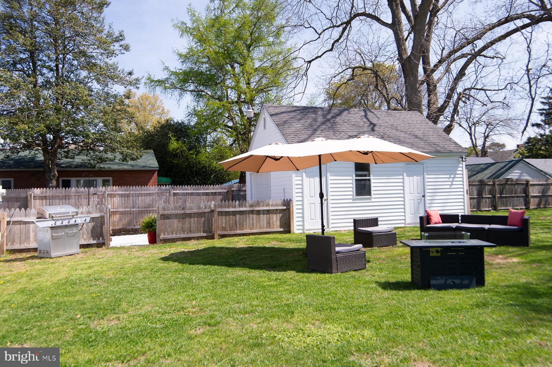310 Talbot Avenue Cambridge, MD 21613 - Photo 41 of 68 a view of backyard with table and chairs under an umbrella