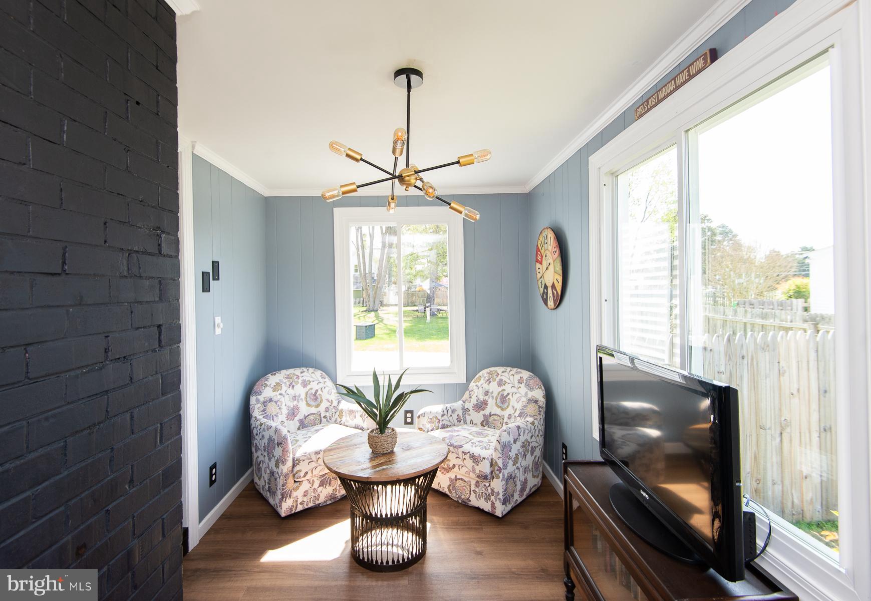 310 Talbot Avenue Cambridge, MD 21613 - Photo 7 of 68 a living room with furniture and a chandelier