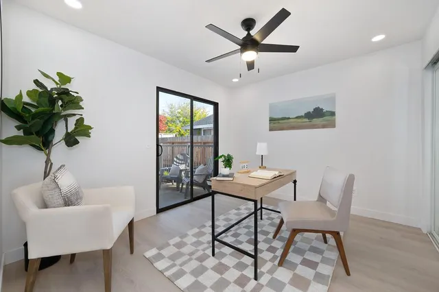 a view of a room with furniture and chandelier