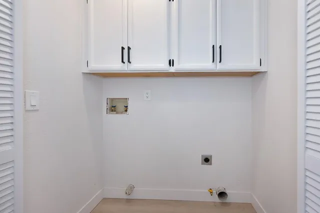 a view of a pathway of a house with a tree beside a yard