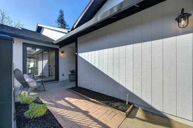 a view of a backyard with wooden fence