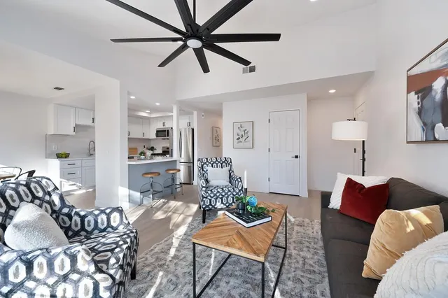 a living room with furniture and a wooden floor