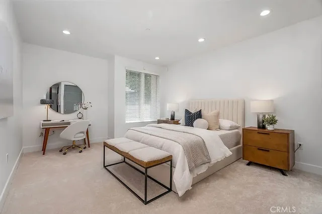 a bed room with a bed and a chair