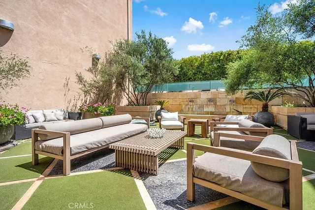 a view of a patio with couches chairs and a table and chairs with garden view