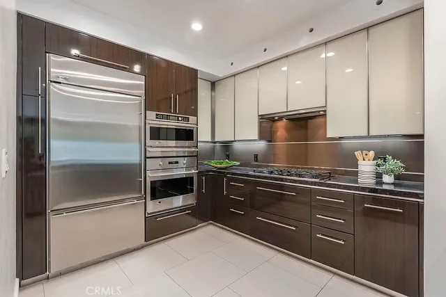 a kitchen with granite countertop stainless steel appliances and counter space
