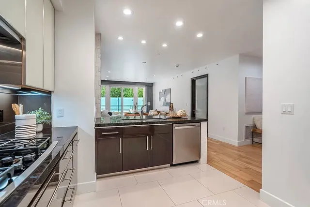 a kitchen with stainless steel appliances granite countertop a stove and a sink
