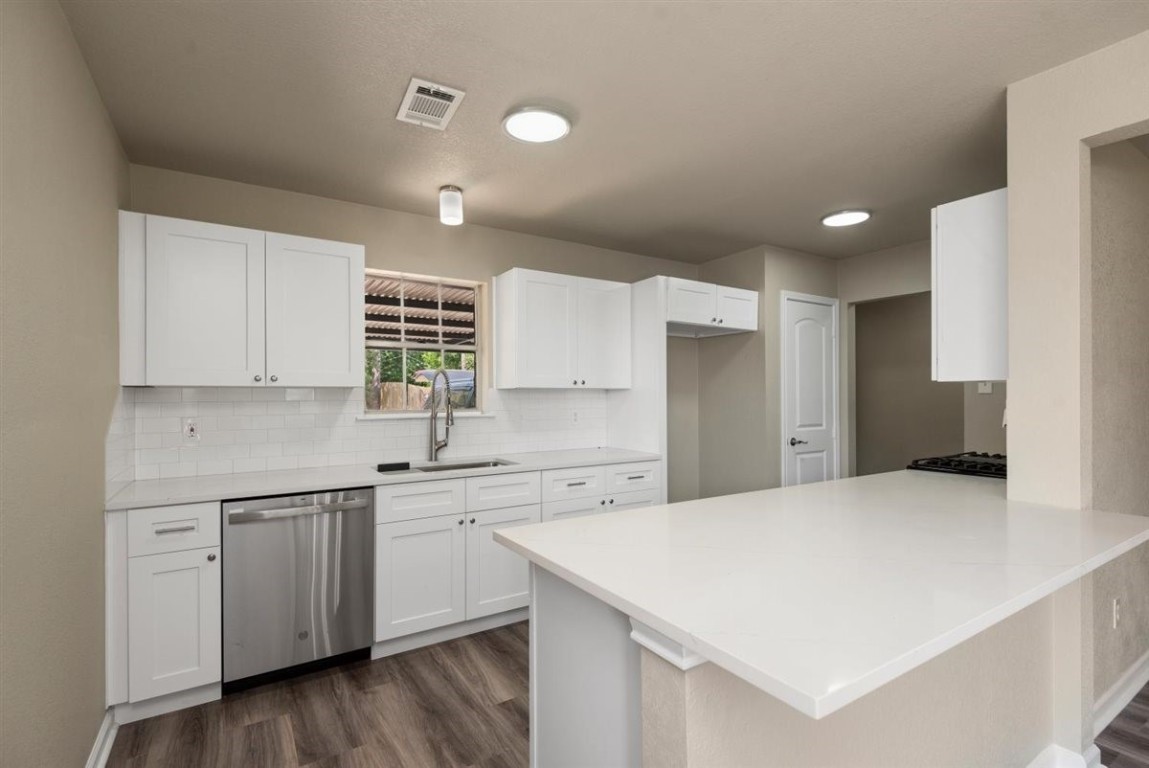 20618 Nannette Lane Spring, TX 77388 - Photo 11 of 32 a kitchen with a sink a center island cabinets and a window