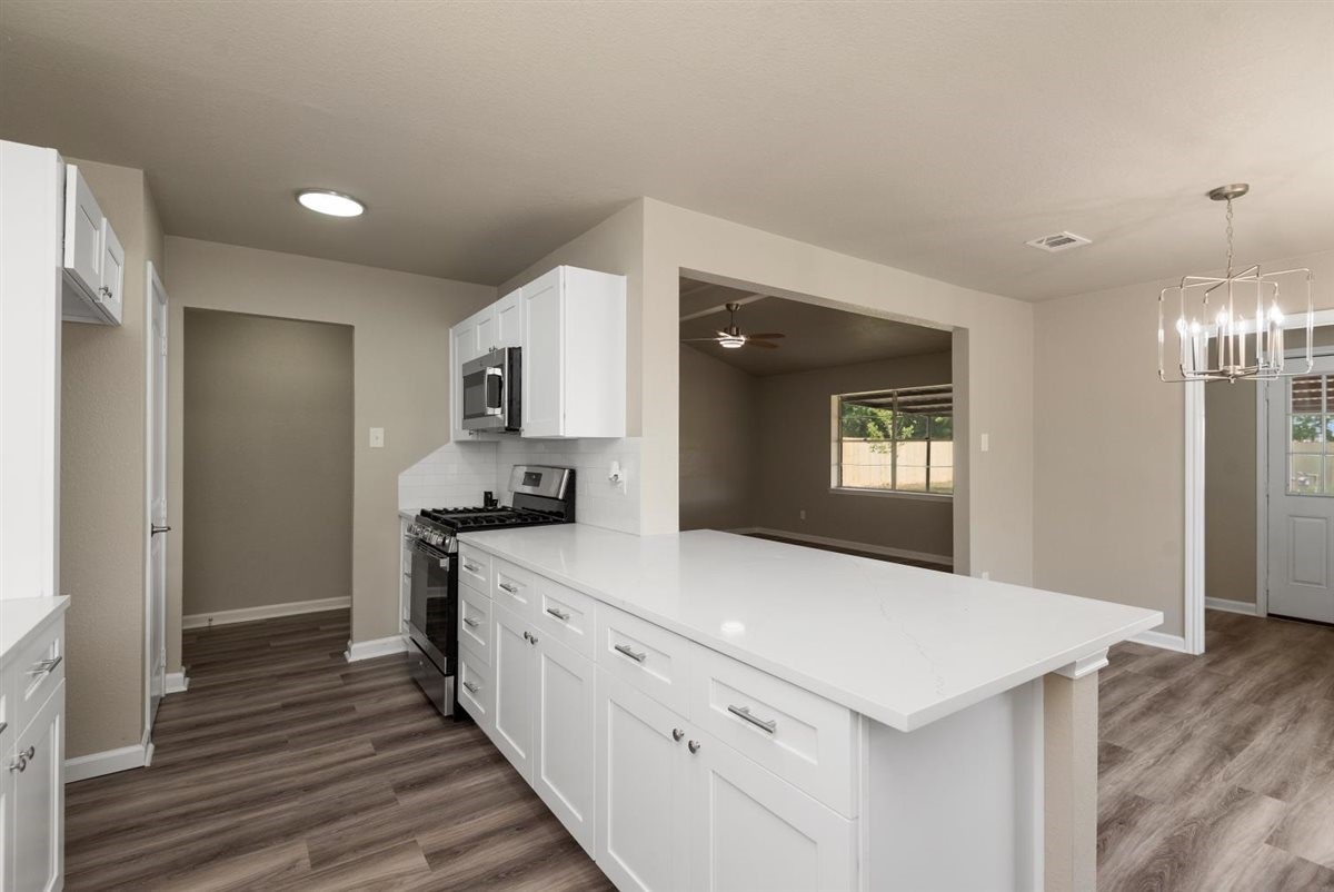 20618 Nannette Lane Spring, TX 77388 - Photo 12 of 32 a kitchen with a sink and a refrigerator