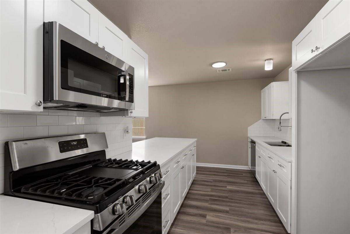 20618 Nannette Lane Spring, TX 77388 - Photo 13 of 32 a kitchen with stainless steel appliances a stove and a microwave