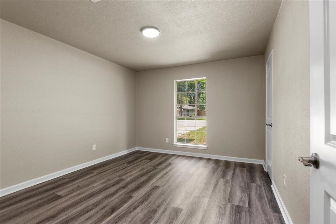 20618 Nannette Lane Spring, TX 77388 - Photo 15 of 32 an empty room with wooden floor and windows