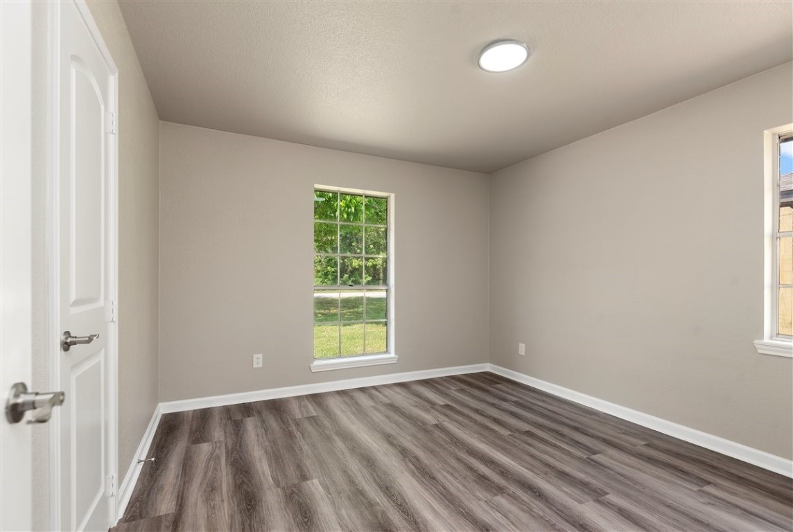 20618 Nannette Lane Spring, TX 77388 - Photo 16 of 32 an empty room with wooden floor and windows