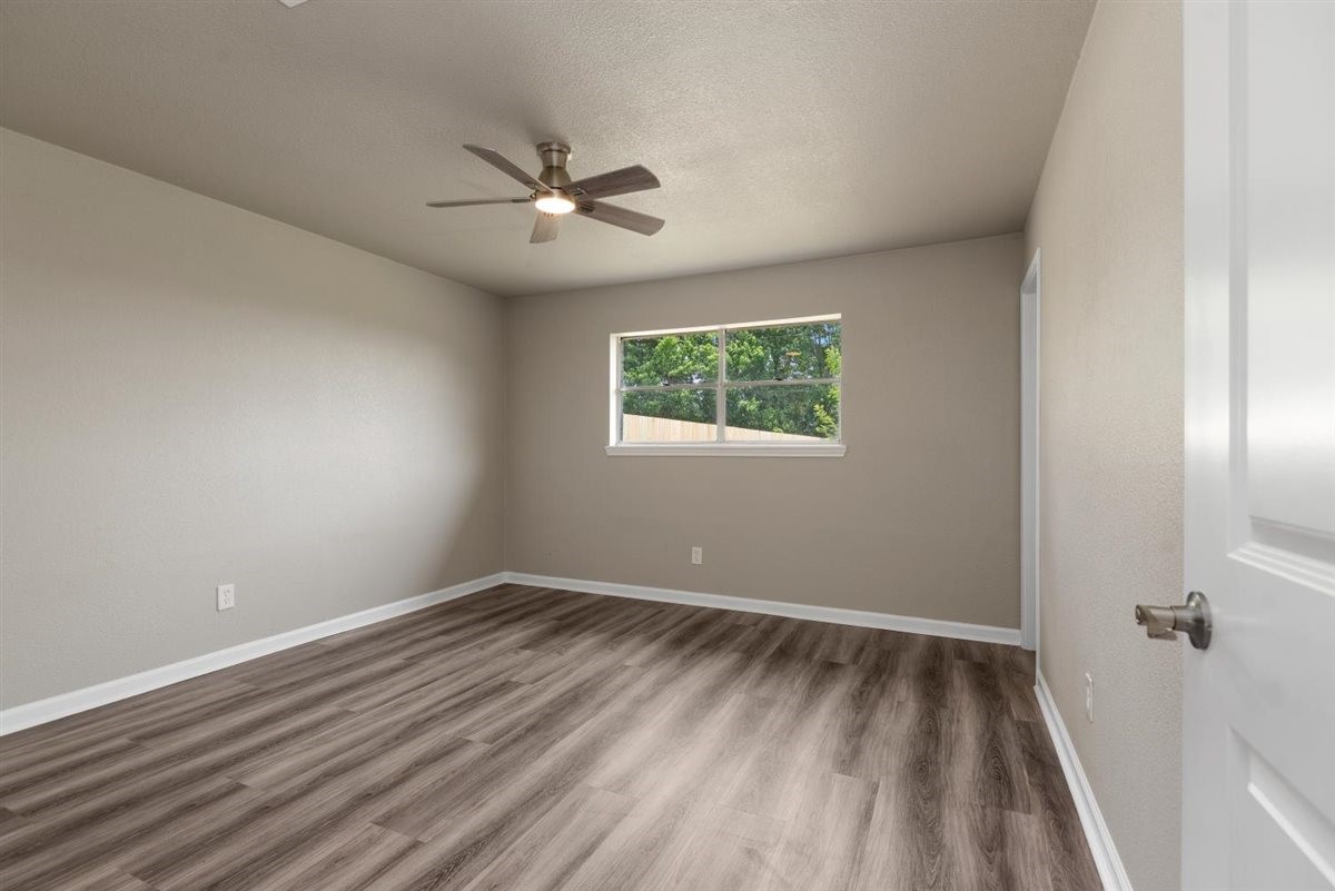 20618 Nannette Lane Spring, TX 77388 - Photo 19 of 32 a view of a room with wooden floor closet and windows