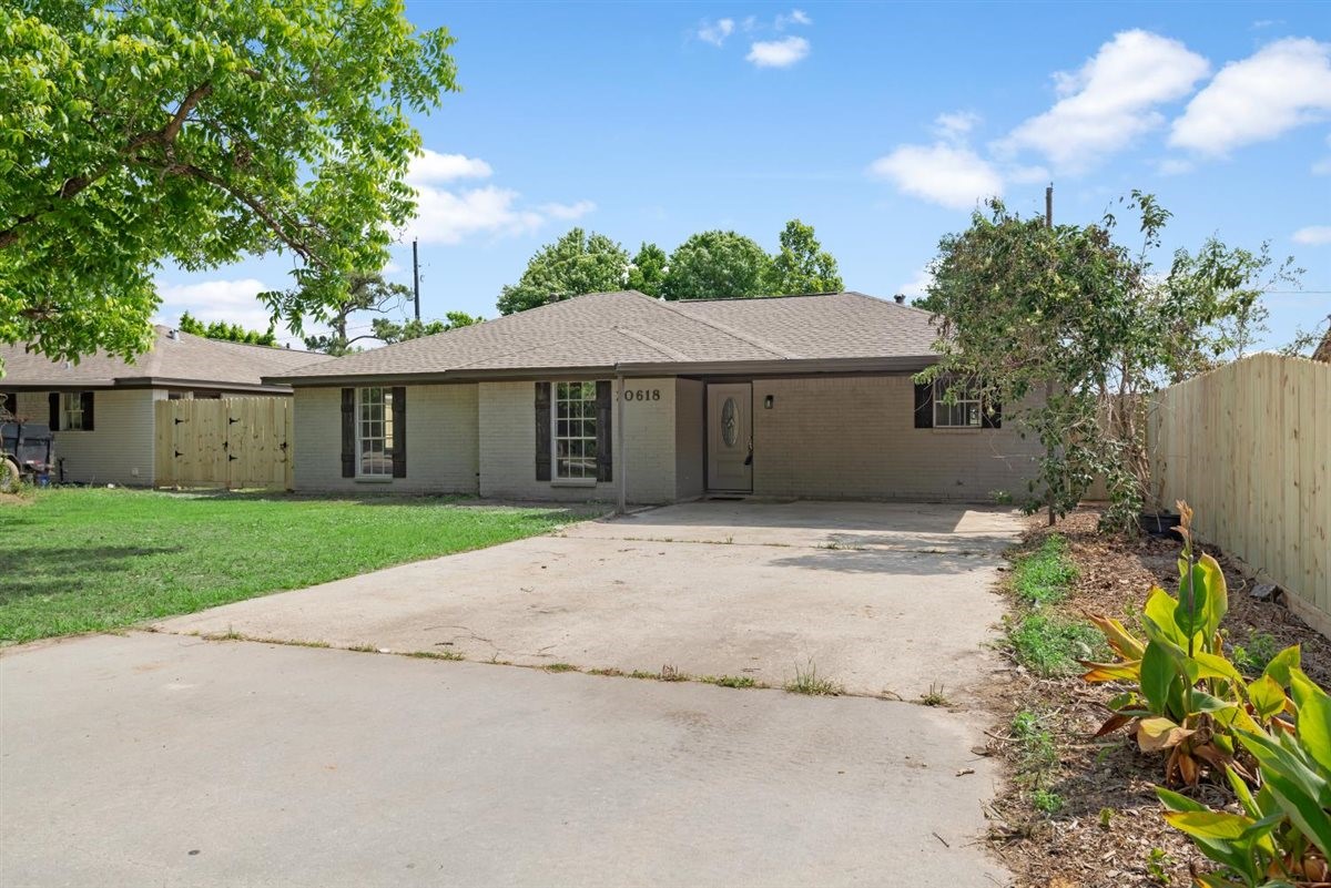 20618 Nannette Lane Spring, TX 77388 - Photo 2 of 32 a front view of a house with a garden and yard