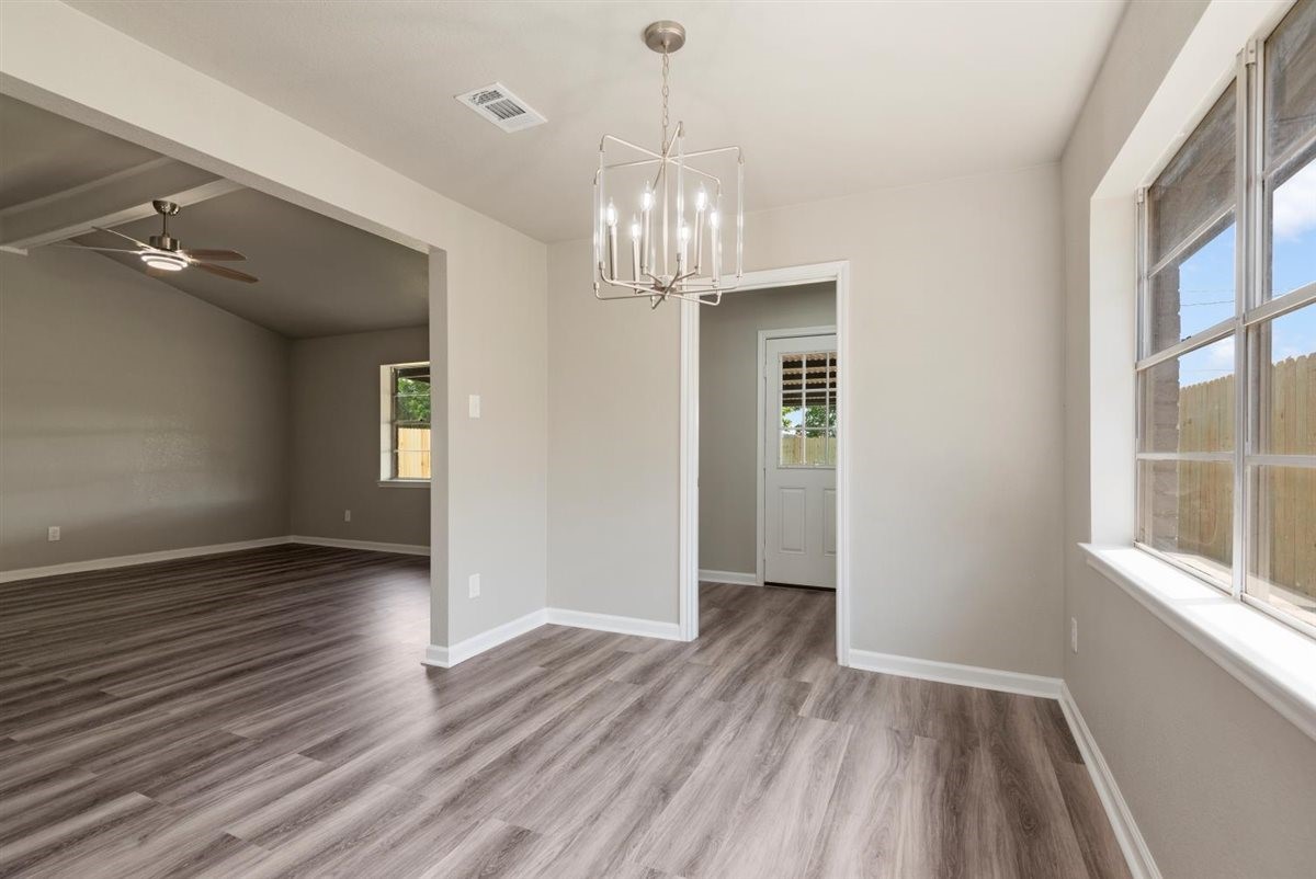 20618 Nannette Lane Spring, TX 77388 - Photo 10 of 32 a view of an empty room with wooden floor and a window