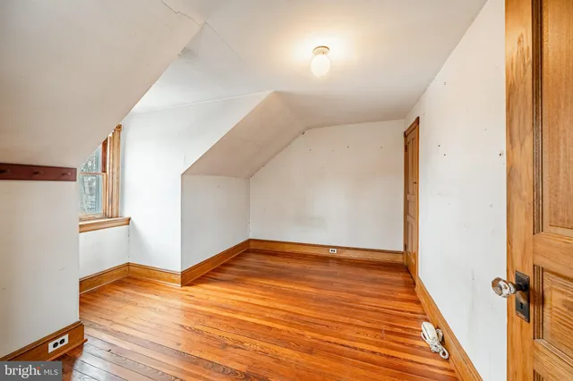 a view of a room with wooden floor and staircase