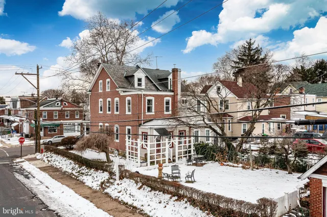 a view of a house with snow on the road