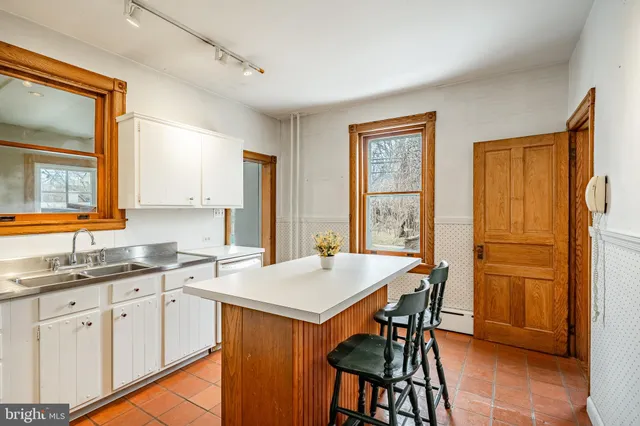 a kitchen with a sink stove and cabinets