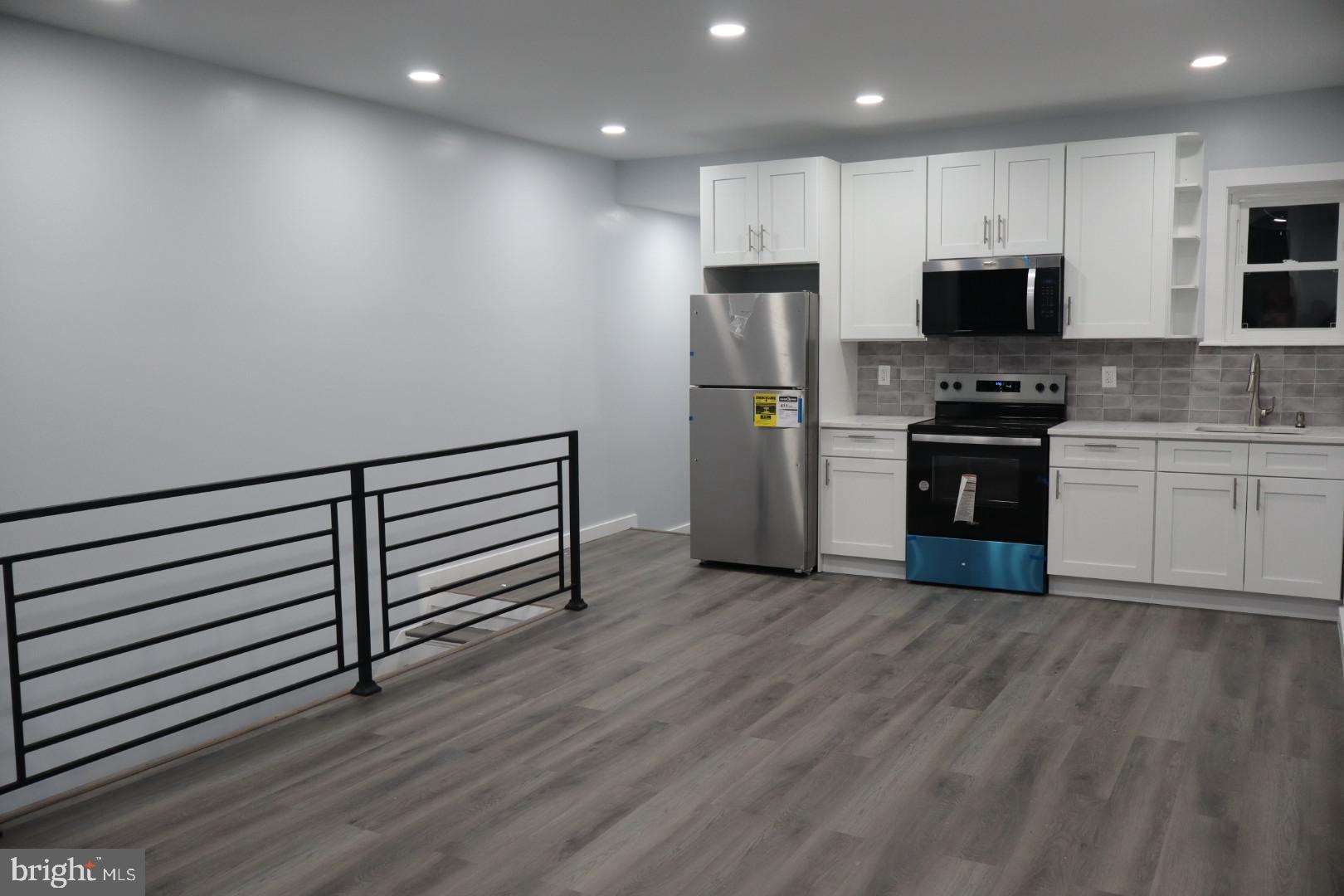2728 North 5th Street Philadelphia, PA 19133 - Photo 1 of 7 a kitchen with stainless steel appliances a stove top oven a sink and a refrigerator