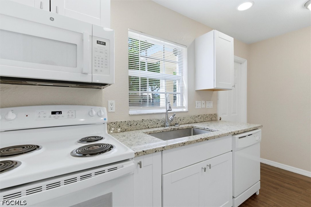 5257 Leeds Road Fort Myers, FL 33907 - Photo 12 of 30 a kitchen with a sink stove top oven and cabinets