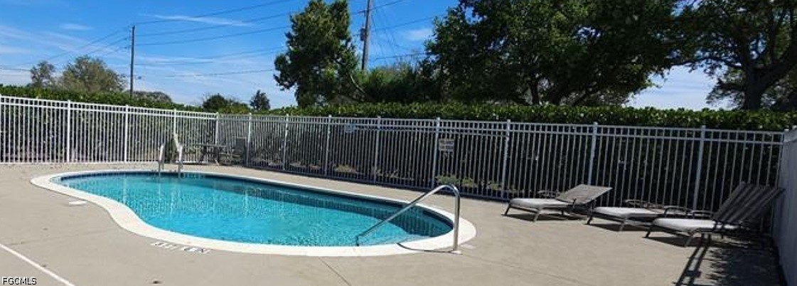 5257 Leeds Road Fort Myers, FL 33907 - Photo 30 of 30 a view of a swimming pool with a chair and wooden fence