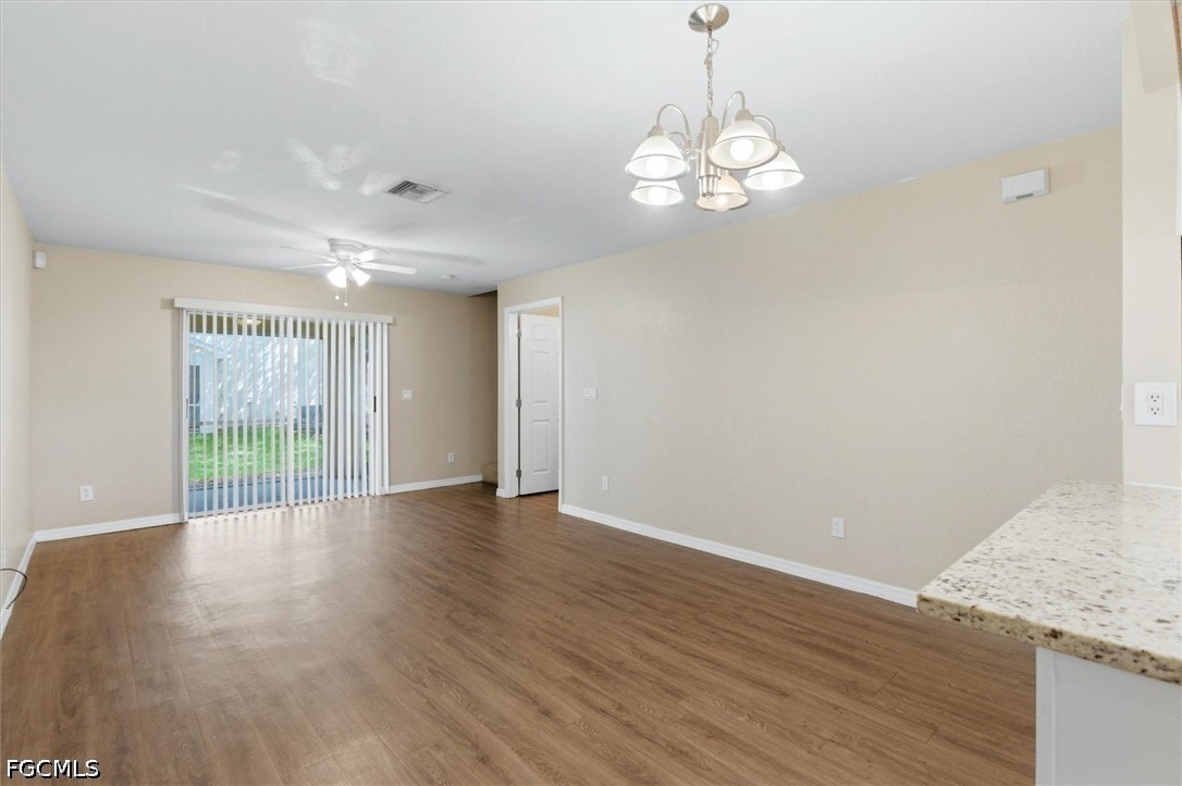 5257 Leeds Road Fort Myers, FL 33907 - Photo 4 of 30 a view of an empty room with wooden floor and a window