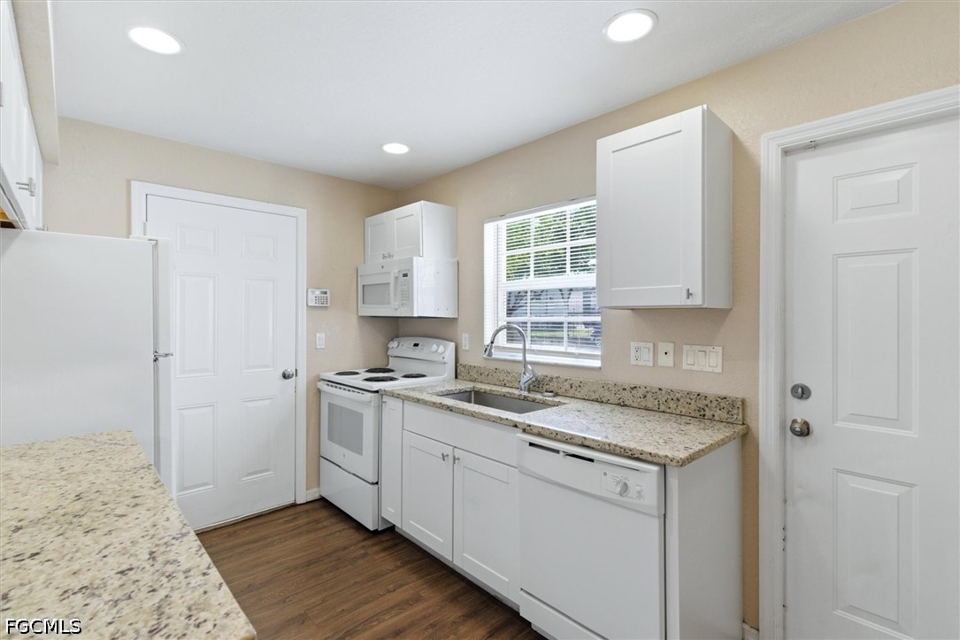 5257 Leeds Road Fort Myers, FL 33907 - Photo 10 of 30 a kitchen with a sink stove and cabinets