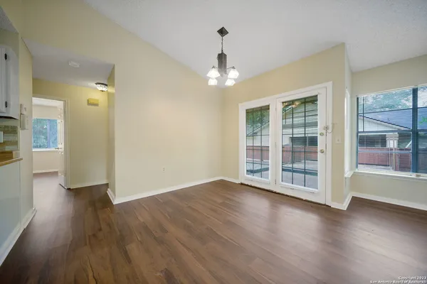 a kitchen with a refrigerator and white cabinets