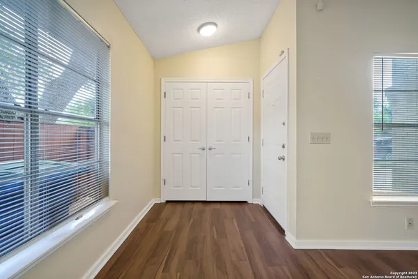 wooden floor in an empty room with a window