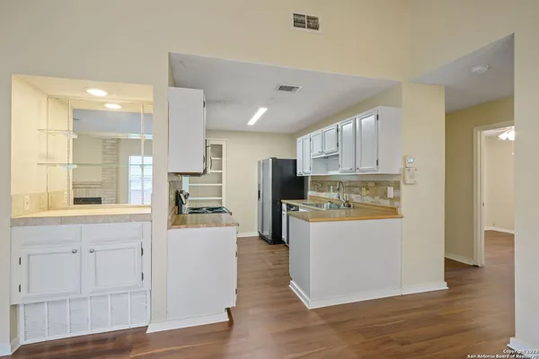 a kitchen with stainless steel appliances a sink stove and cabinets