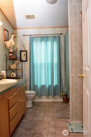 a bathroom with a toilet a sink and shower