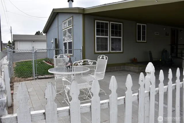 a table and chairs in front of a house