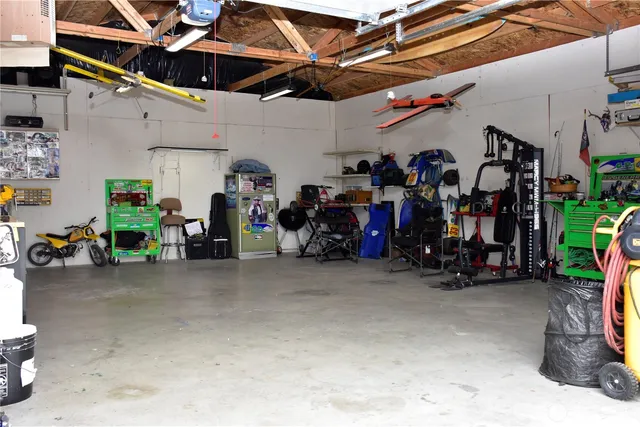 a view of a garage with a bike and white walls