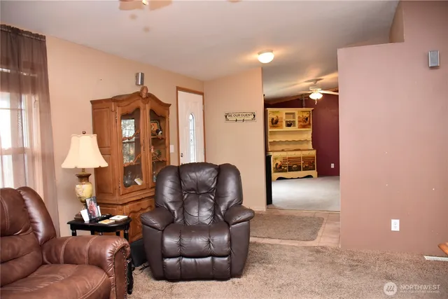 a living room with furniture and a lamp