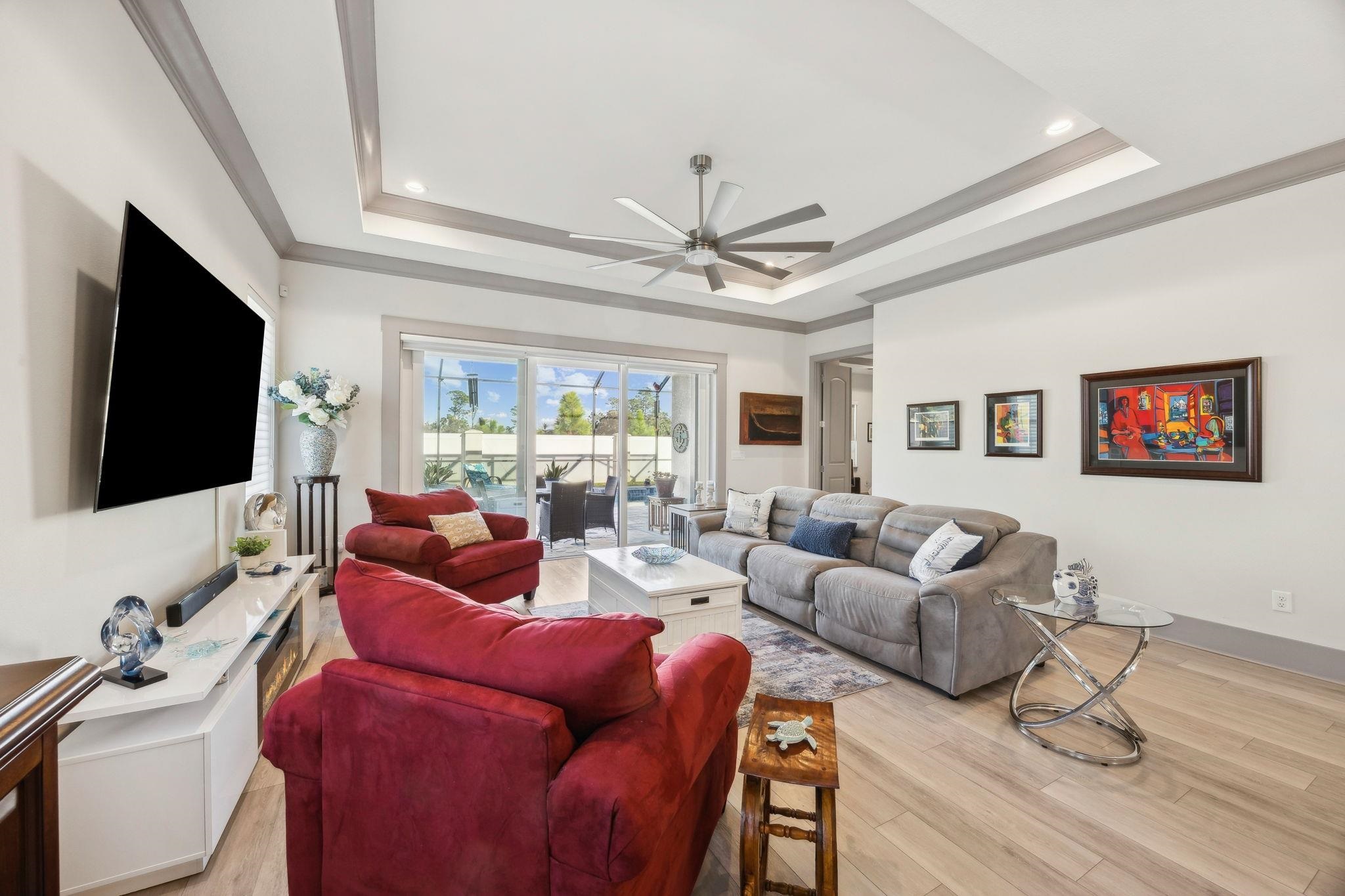 18 Rio Vista Drive Palm Coast, FL 32137 - Photo 25 of 73 a living room with furniture a flat screen tv and a large window