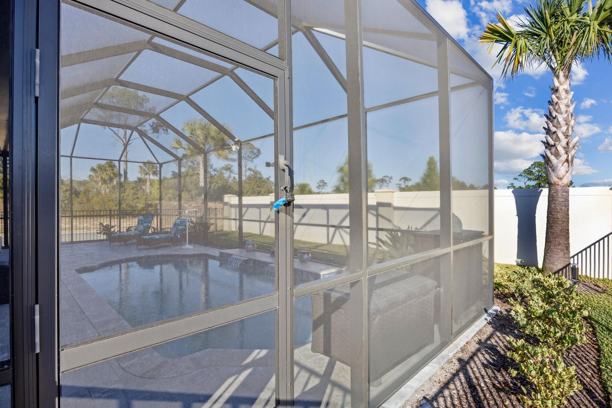 18 Rio Vista Drive Palm Coast, FL 32137 - Photo 34 of 73 View of swimming pool with glass enclosure, a sunroom, and a fenced backyard