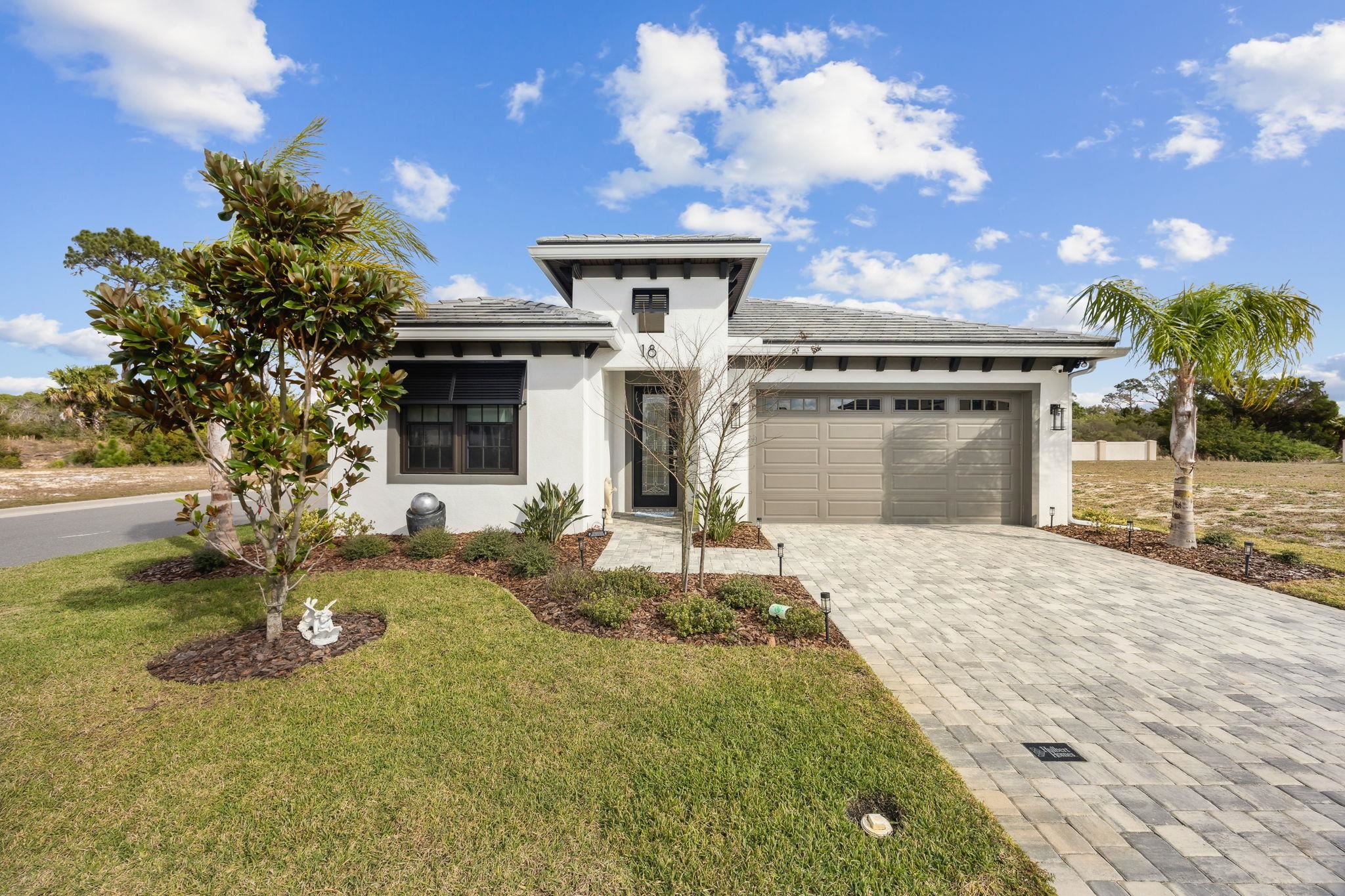18 Rio Vista Drive Palm Coast, FL 32137 - Photo 4 of 73 a front view of a house with a yard and garage