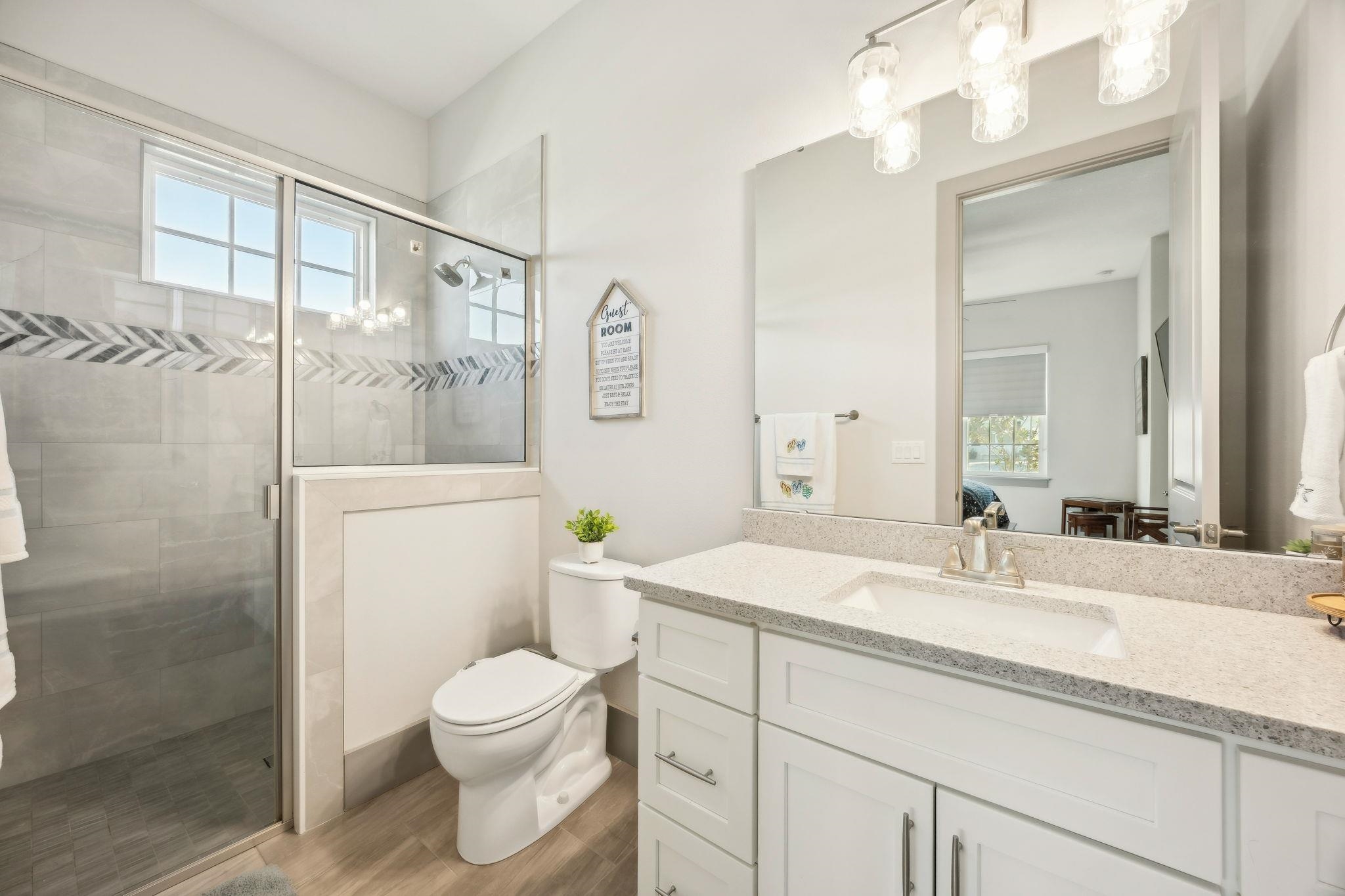 18 Rio Vista Drive Palm Coast, FL 32137 - Photo 46 of 73 a bathroom with a granite countertop sink a toilet and shower