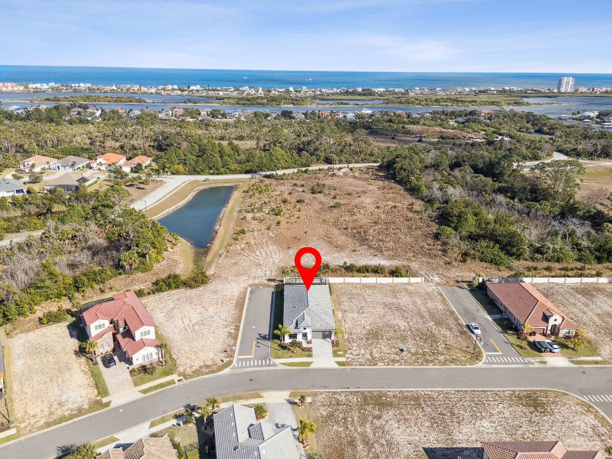 18 Rio Vista Drive Palm Coast, FL 32137 - Photo 52 of 73 Aerial view of property and surrounding area featuring a large body of water and nearby suburban area
