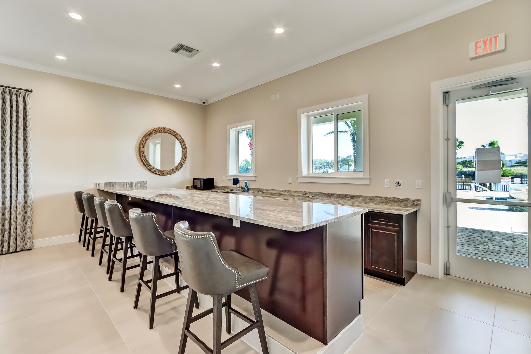 18 Rio Vista Drive Palm Coast, FL 32137 - Photo 62 of 73 Kitchen featuring a breakfast bar area, light stone countertops, recessed lighting, ornamental molding, and dark brown cabinets