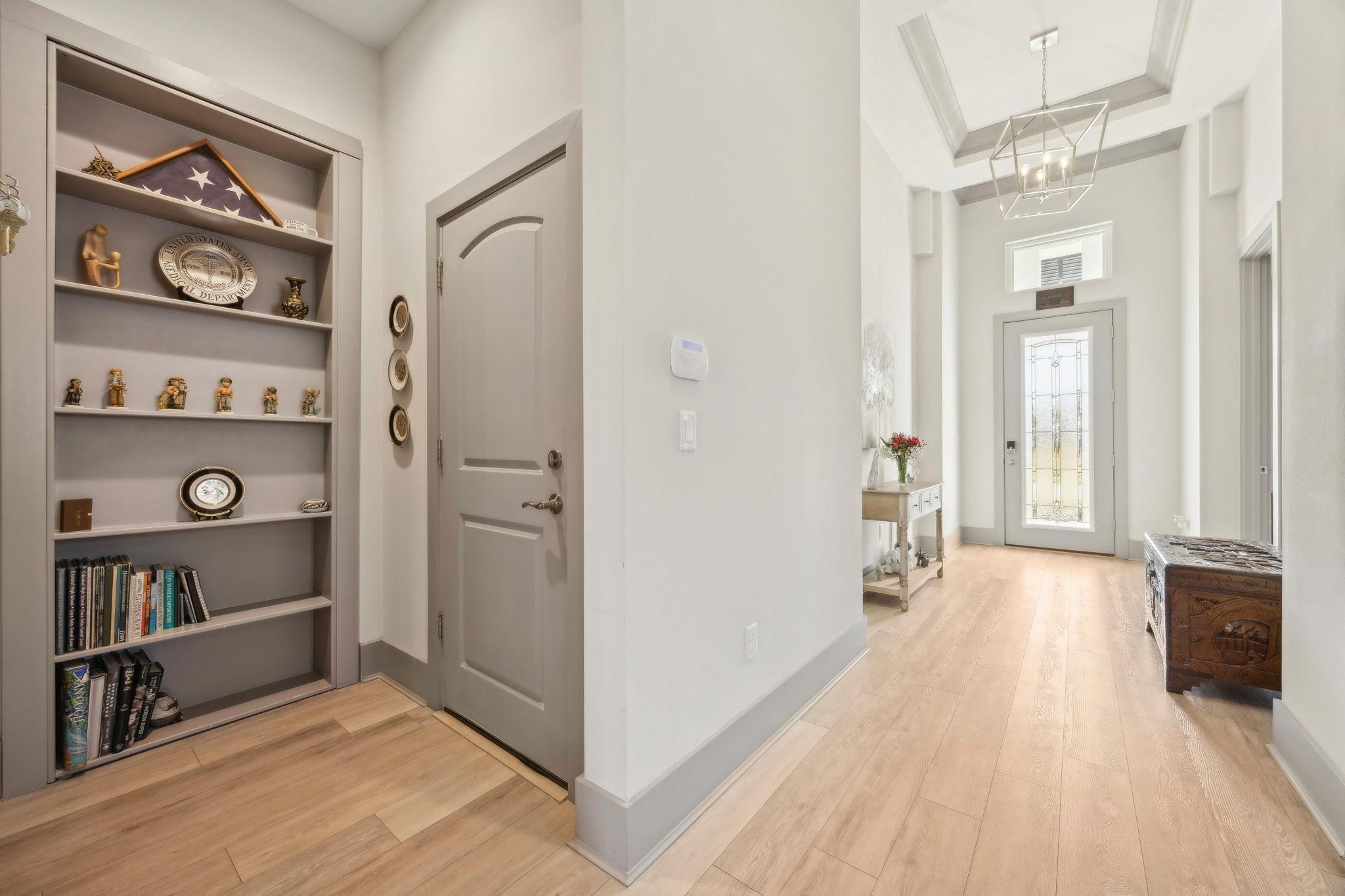 18 Rio Vista Drive Palm Coast, FL 32137 - Photo 9 of 73 Foyer entrance with light wood finished floors, a chandelier, a raised ceiling, and a high ceiling