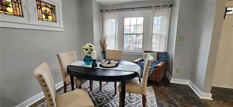 a view of a dining room with furniture and window