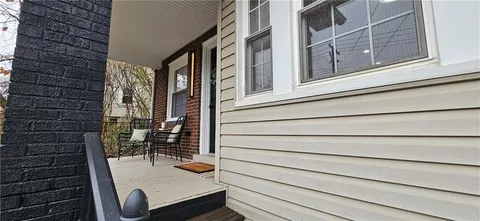 a view of a balcony with a door and a window