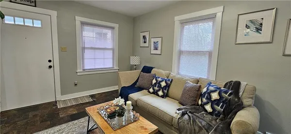 a living room with furniture a mirror and a fireplace