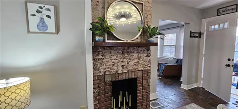 a view of hall way with furniture and a potted plant