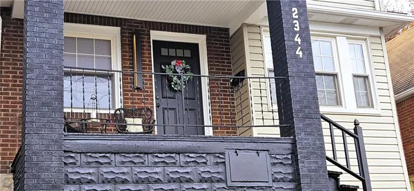 a view of a brick house with large windows