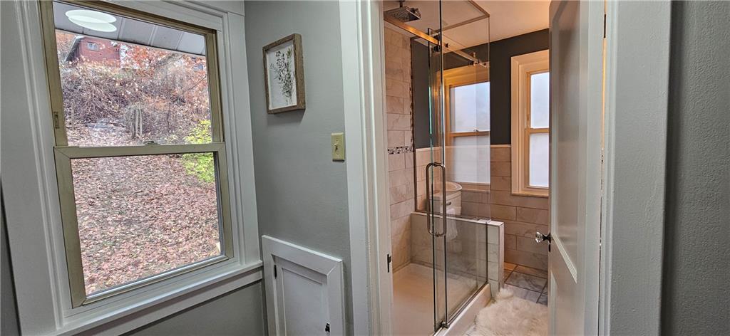 2344 Saranac Avenue Pittsburgh, PA 15216 - Photo 22 of 48 a bathroom with a glass shower door and a wooden door