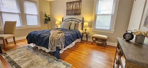a bedroom with a bed and a mirror