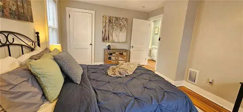 a bed sitting in a bedroom next to a window