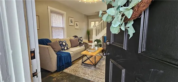 a living room with furniture and a potted plant
