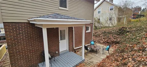 a balcony with table and chairs